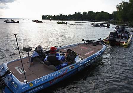 The Bassmaster pros idle through the take off inspection and out toward the middle of Oneida Lake where they will race away to the first stops of the day.