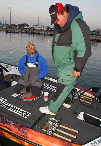 Angler Kenyon Hill (19th, 25-8) appears to admire the gear on the deck of Jason Quinn's boat as Quinn laughs.