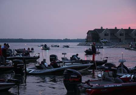 A line of Southern Open pros and their co-anglers launch in the distance as the sun begins to rise.