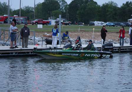 Elite Series pro Timmy Horton makes his way through the BASS inspection as a fan takes his photo in passing.