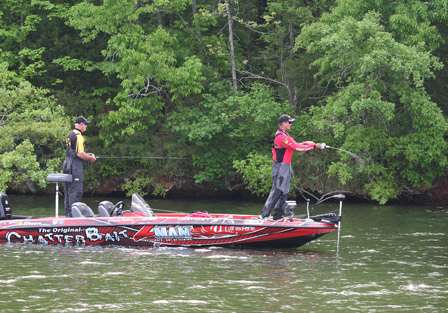 Elite Pro Casey Ashley makes a cast as his co-angler Tommy Swindle looks on.