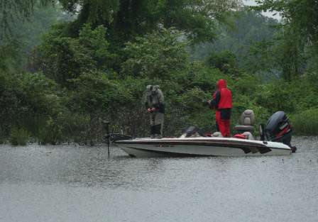 Pro Butch Tucker zips up against the rain as it breaks loose once again on the anglers on Wheeler Lake.