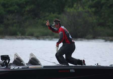 Payne hurries to the livewell and throws up three fingers to signal the numbers of keepers he has in the boat.