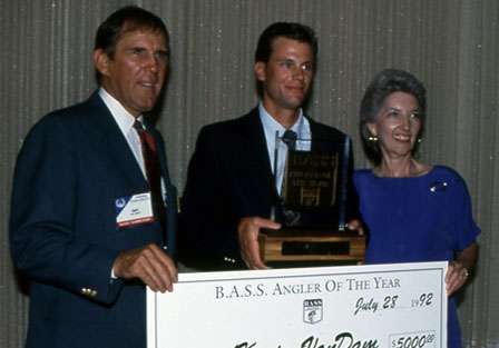 Ray Scott and Helen Sevier present VanDam with his first Bassmaster Angler of the Year award and check in 1992.