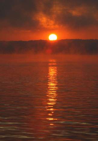 The sun rises on Kentucky Lake with the anglers still stuck at the ramp due to a fog delay. 