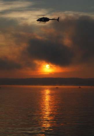 An ESPN camera films the action from a helicopter as the sun begins to burn off the fog on the final day.