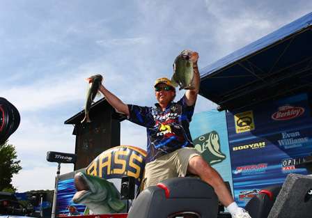 Rick Morris holds up two of his best fish to show the crowd part of his Day Four bag.
