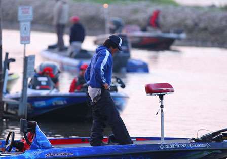 Kota Kiriyama gets ready for the Day Two launch of the Genuity River Rumble by pulling on his rain pants.