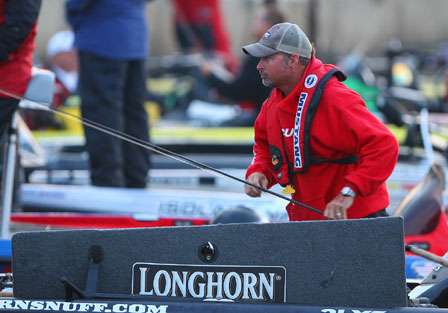 Jeff Kriet pulls a few rods out of the box as he gets ready for another day on the Mississippi River in the Genuity River Rumble.