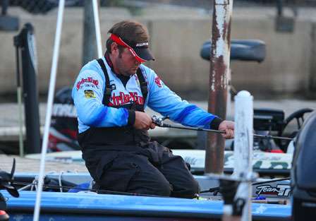 River rat Greg Hackney had a disappointing Day One on the Mississippi River and kneels on the front deck on the morning of the second day to prepare his tackle for a comeback performance.