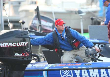 Todd Faircloth pushes off another competitor's boat in the crowded conditions at the Day Two launch.