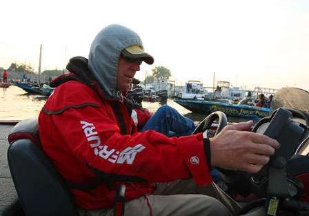 Rick Morris pulls up his hood and readies his electronics for making an early morning run across the Mississippi River.