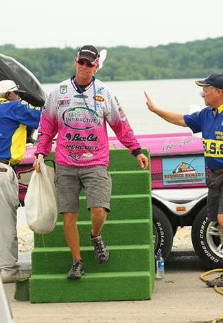 Kevin Short steps down from his boat with a limit weighing 11 pounds, 13 ounces on Day Four.