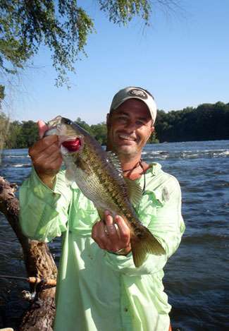 James Hall holds up a very nice representative of the spotted bass. This 16-incher ate a craw dragged through an eddy.