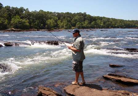 Chris Horton targets redeye in the calmer seams of the rough current of the Tallapoosa River.