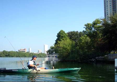 Chris Horton fishes Lady Bird Lake, overshadowed by high rises of downtown Austin, Texas.