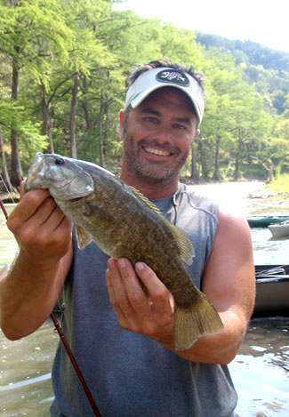 Hall catches what turns out to be a smallmouth/Guadalupe hybrid out of some fast-moving water.