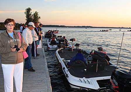 Fans line the dock to watch the field of competitors take to the lake on the first day of competition.