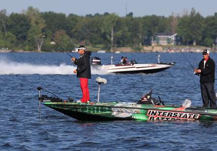 Pro Mark Kulik never looks up from fishing as boats running the canal throttle past him.