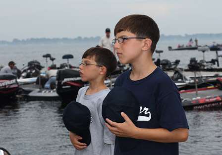 Taso and Ioanni Kovack pay homage to the flag as the national anthem is played. They are also the youngest volunteers at Northern Open #2 on Lake Champlain.