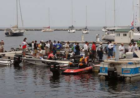 The anglers line up to receive a bass transport bag.