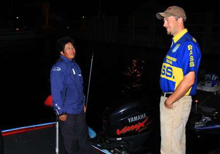 Bassmaster Elite pro Takahiro Omori goes through the motions of the BASS safety and boat inspection while he waits at the dock for launch time.