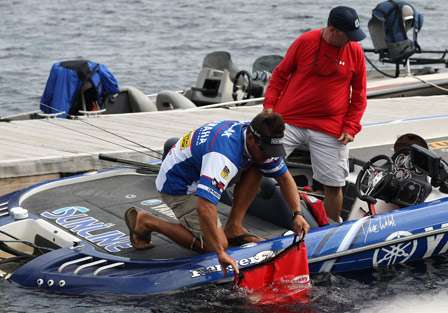Bassmaster Elite Series pro Dave Wolak fills his transport bag with lake water before loading it with bass.
