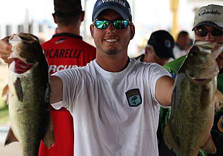 Jason Knapp holds up two of the bass that boosted him to the top and placed him in the hot seat.