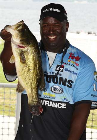 Elite Series pro Ish Monroe holds up a pig of a largemouth that he caught five minutes before weigh in and within sight of the stage. It would take big bass honors for Day Three.