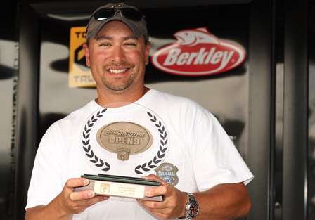 The co-angler Champion for the second Bassmaster Northern Open Christopher Hall is all smiles as he holds his trophy on the Bassmaster stage. He will also take home a new Triton bass boat for his efforts.