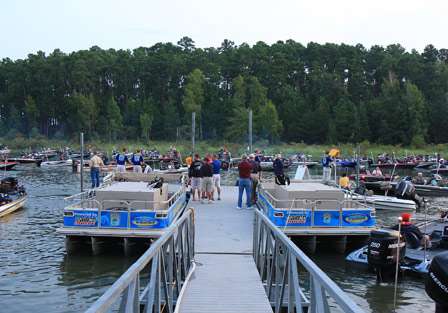 Fans crowd the dock as 193 boats parade through the inspection line and out onto Sam Rayburn Reservoir.