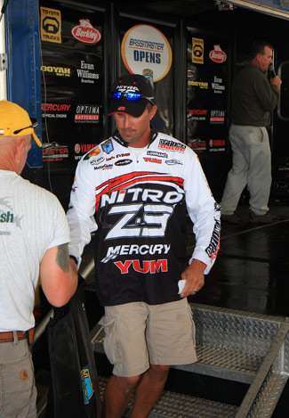 Elite Series pro Edwin Evers steps down from the Bassmaster Open stage and grabs his weight receipt and his transport bag containing his limit, which will be returned to the release boats.