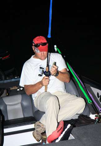 Curtis Metts unwraps his rods and makes final adjustments as he waits for his Day Two pro.
