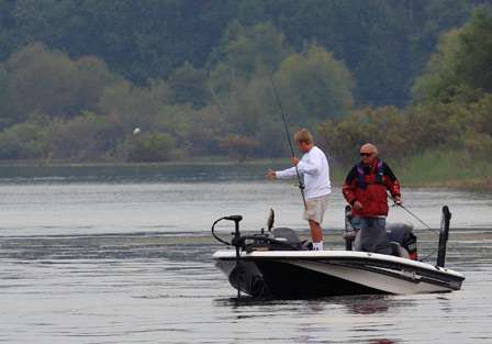 Pro Bill Burns boats a bass as his co-angler Billy Yelverton looks on.