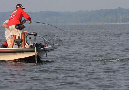 Johnston calls for the net as fights a larger bass to the boat.