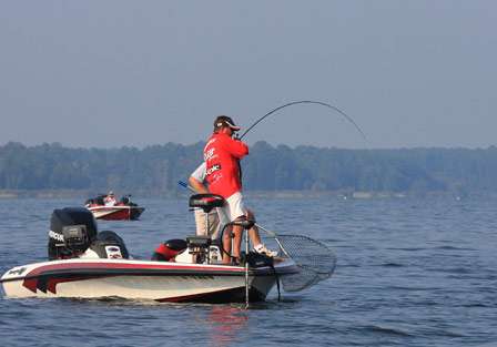 Pro Stephen Johnston sets the hook on another nice bass as his co-angler, Bobby Lanham, readies the net.
