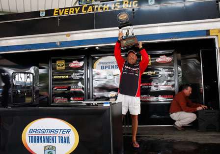 Champion Stephen Johnston holds the trophy high in the air as he takes the Bassmaster Central Open win on Sam Rayburn Reservoir.