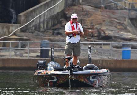 As water begins to pour from Mitchell Dam, Tommy Biffle positions his boat in an eddy and begins casting. 