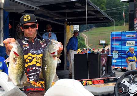 Mike Iaconelli wrestles his two largest fish from the live well. 