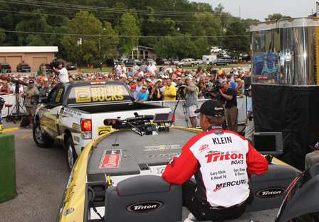 Elite pro Gary Klein is towed to the weigh-in stage from the back lot as fans look on.
