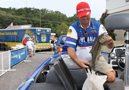 Elite Series pro Todd Faircloth places a Lake Jordon bass into his weigh-in bag before being pulled to the stage.