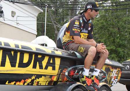 Michael Iaconelli sits on side of his boat sharing fishing stories with fans in the back lot.