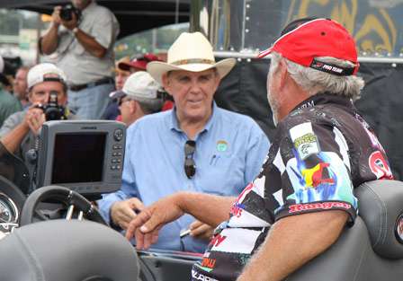 BASS Founder Ray Scott and Elite pro Tommy Biffle share words as Biffle is pulled out in front of the stage.