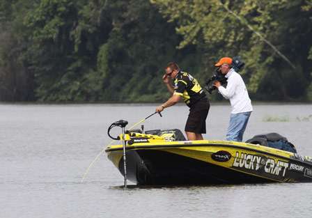 Skeet Reese fights a bass to the side of the boat, taking care not to rush the catch.