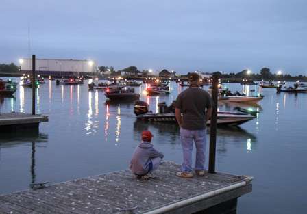 Johnny Hofong and Ryan Wiedle (standing) watched from the dock as the final launch was about to get underway.