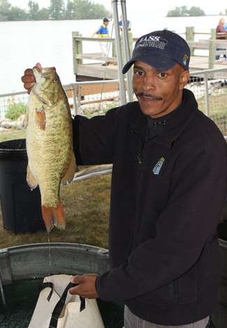 Marvin Stith holds up a nice Lake Erie smallmouth as he waits at the tanks for the weigh-in to begin.