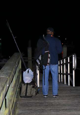 Co-angler Edward Fye awaits his pro at the dock on the first day of the last Bassmaster Southern Open of the year.