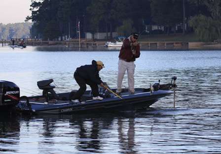 Co-angler Barry Pavia goes for the net as Tim Ezell flips a small keeper bass into the boat.