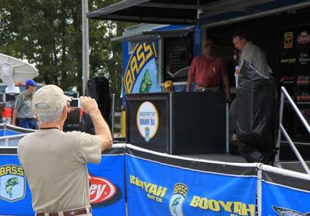 Cecil Wilson takes a photo of his son John Wilson on stage.