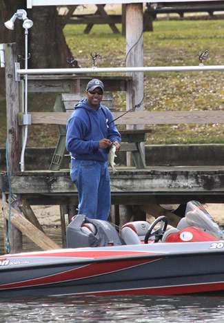 Co-angler Marcus Parker catches a small keeper from under a dock.